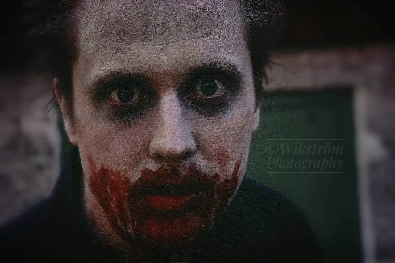 A pale man with blood around his mouth.